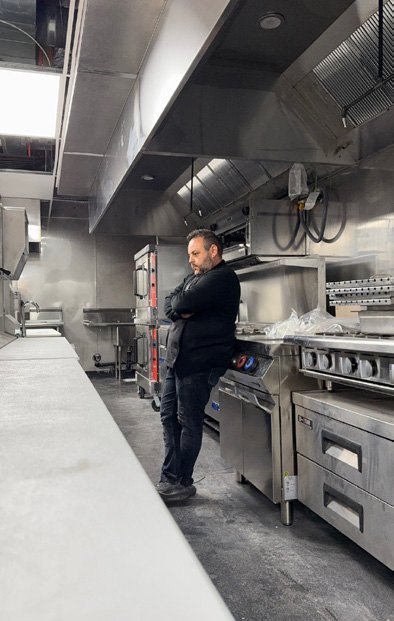Chef Brik reviewing the newly installed kitchen line